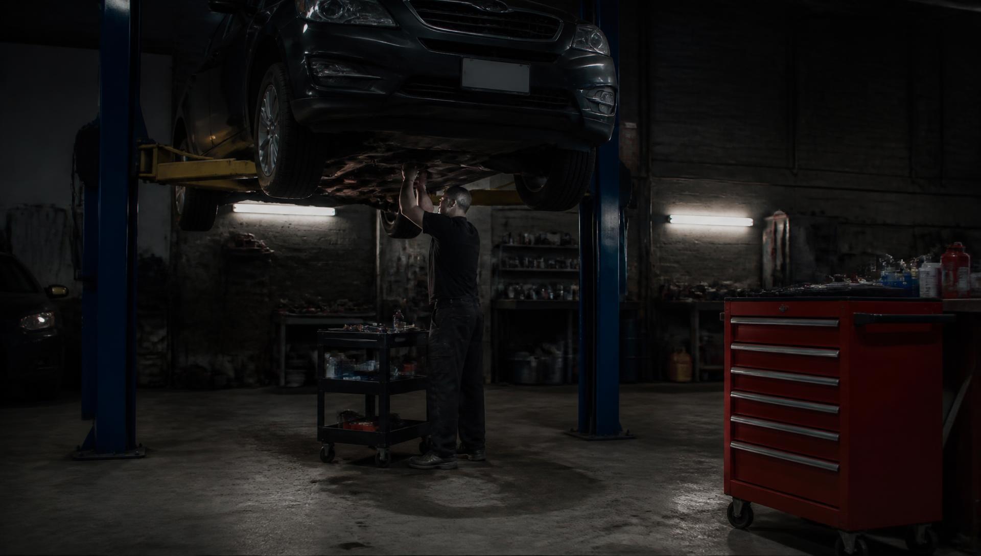 Vehicle on a lift inside the DeStefano Automotive Repair shop